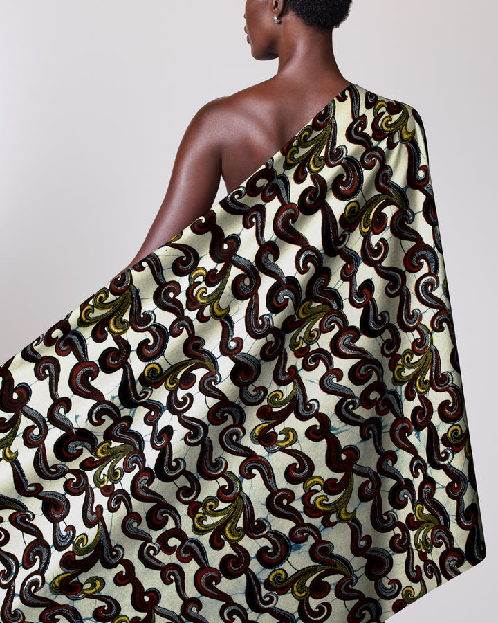 Patterned Wax Hollandais fabric elegantly draped over a person’s shoulder